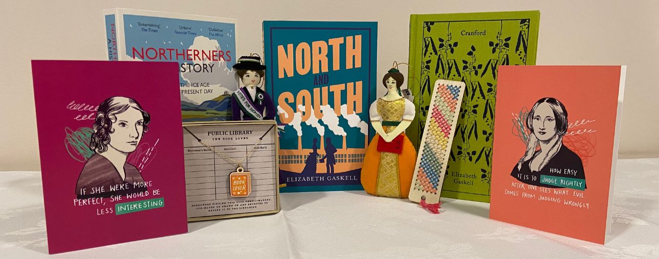 A selection of gift shop items on a white background, including books, a necklace, Christmas decorations and bookmarks.