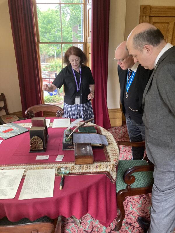 volunteer showing the High Sheriff the place where Elizabeth Gaskell wrote.